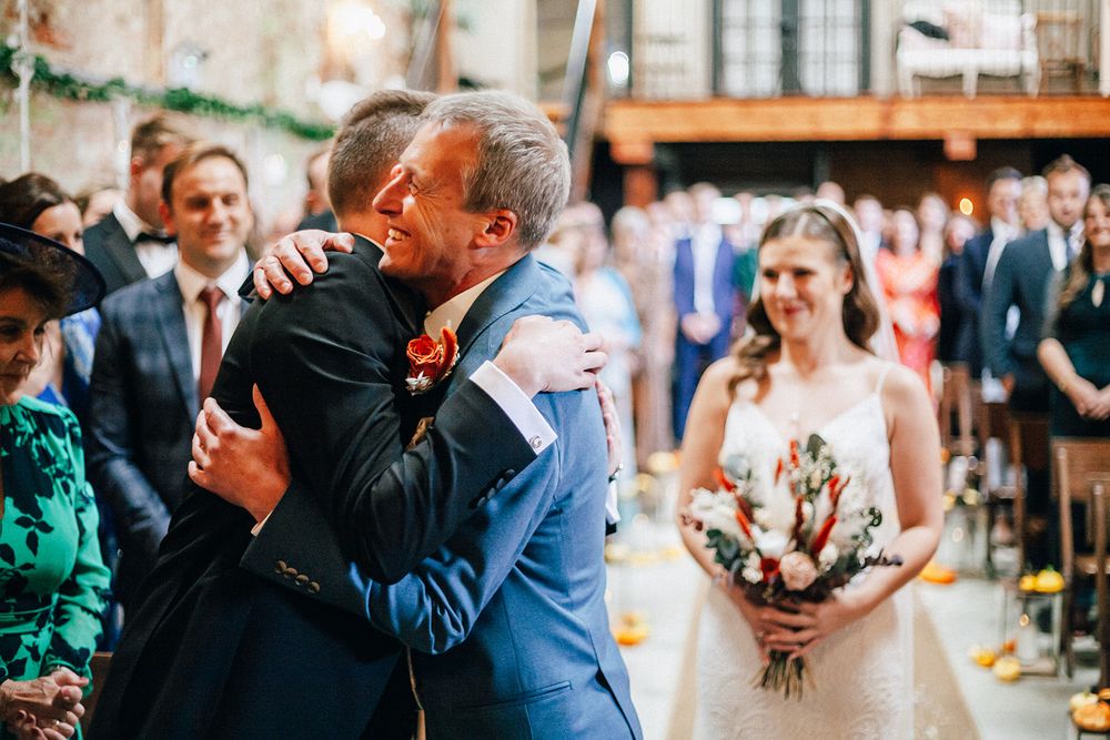 Emotional wedding moments captured in a series of candid photos showing embraces and celebrations at a reception.