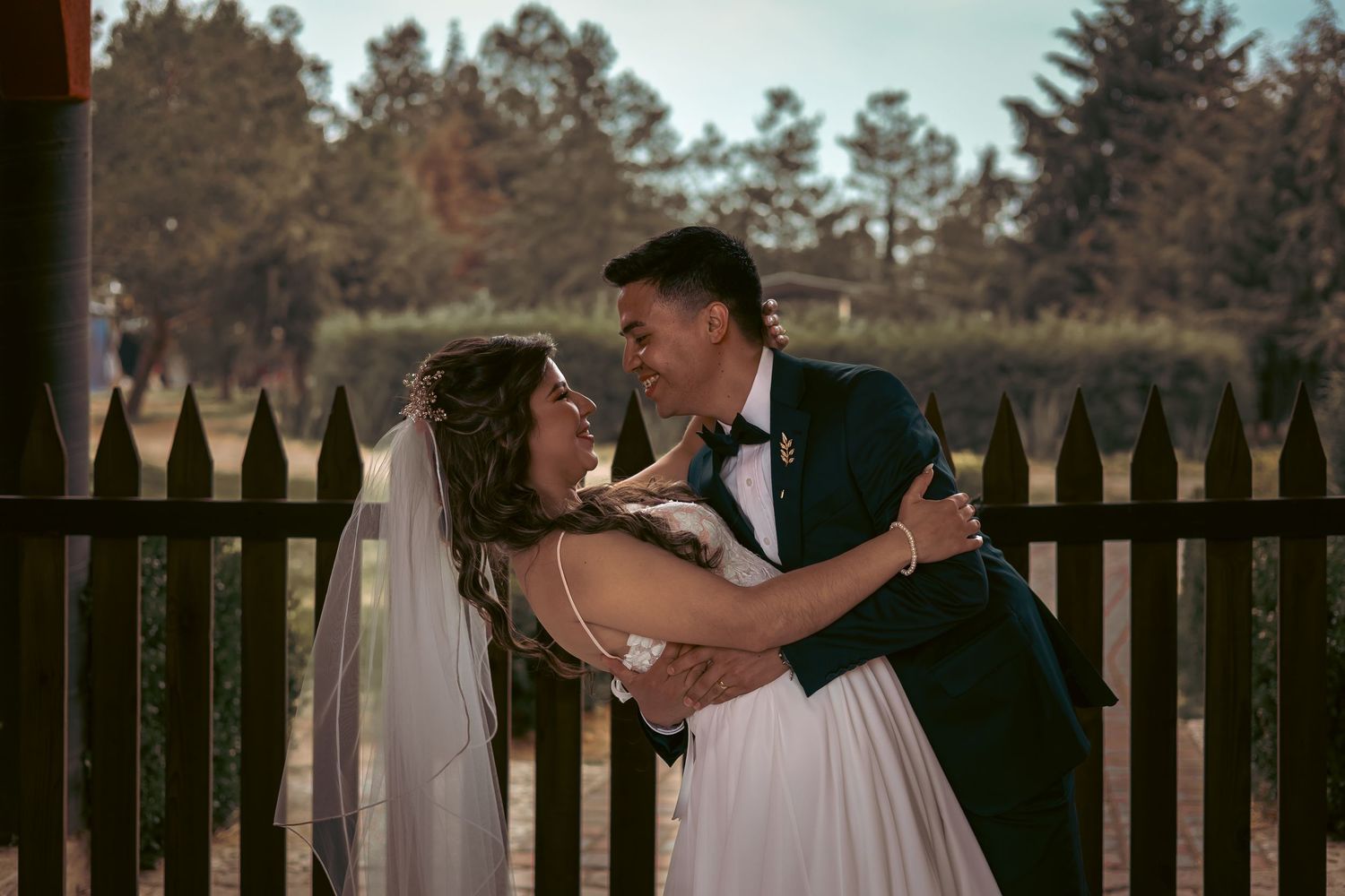 An outdoor wedding photoshoot sequence with pine trees in the background.