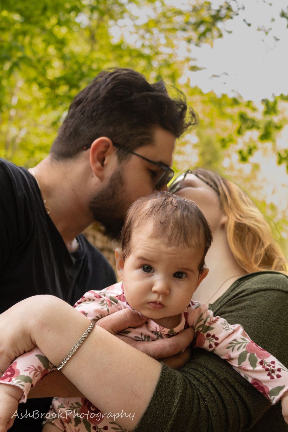 baby in front of parents kissing