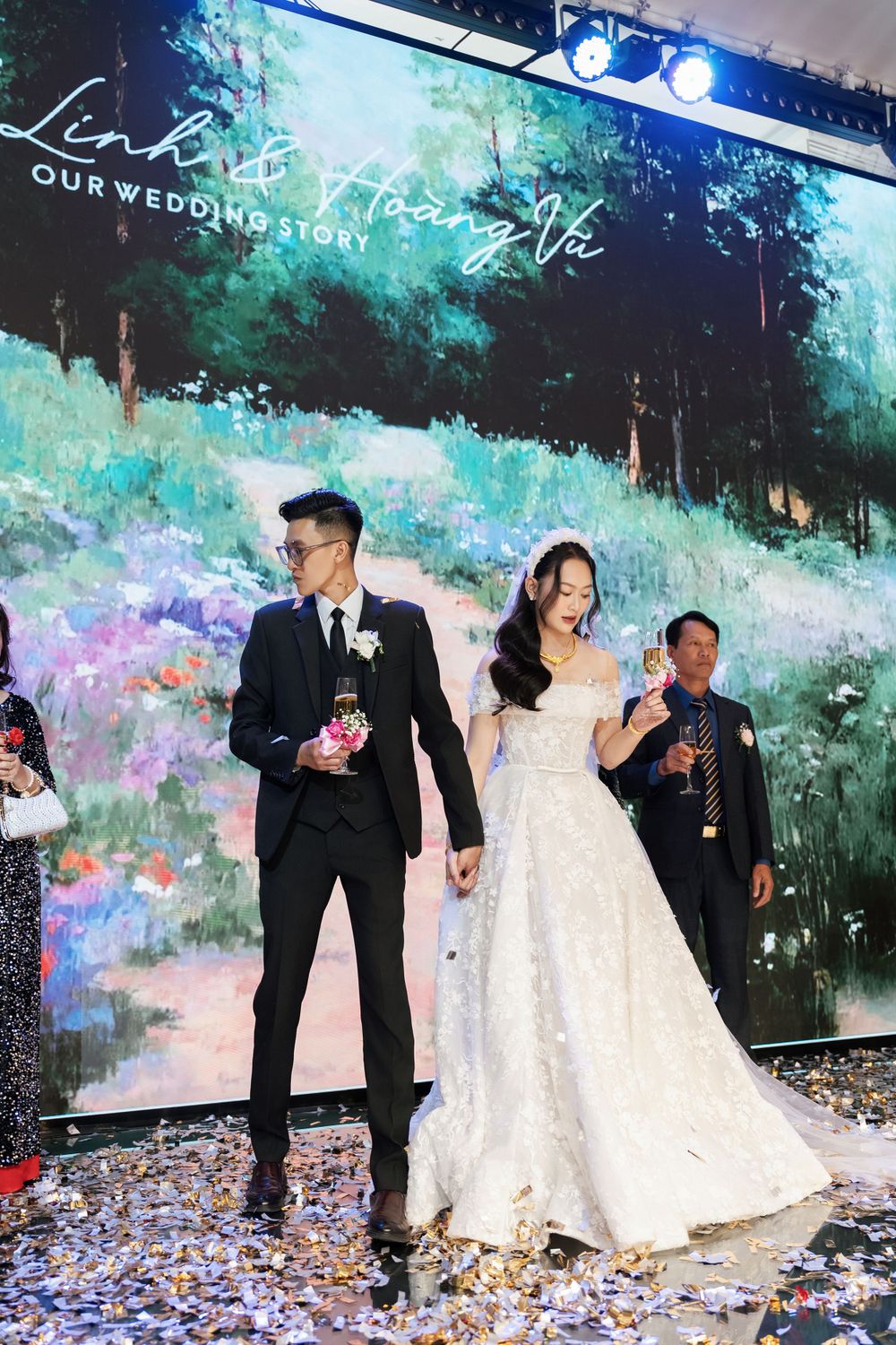 Wedding celebration with confetti and artistic forest backdrop display.