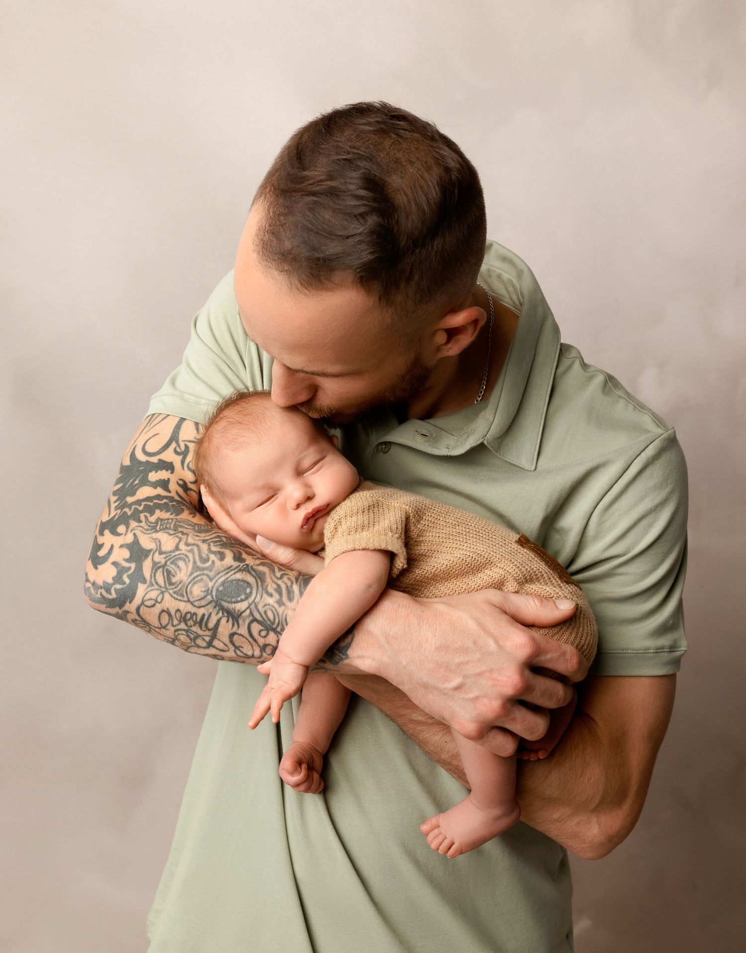 Dad holding their newborn for a newborn session at Stephanie Ann Photography's studio in New Hampshire