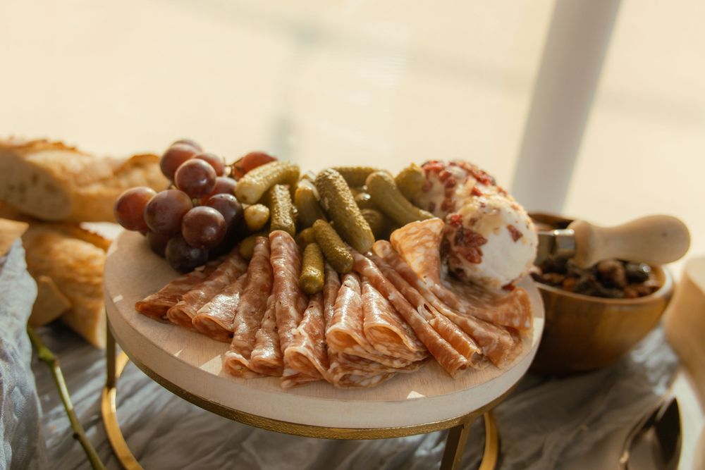 Elegant sushi platter served on wooden board showcasing California rolls and fresh seafood selections.
