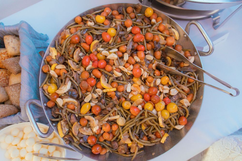 Overhead view of colorful Chinese stir fry dish with noodles, vegetables and mushrooms in a dark wok.