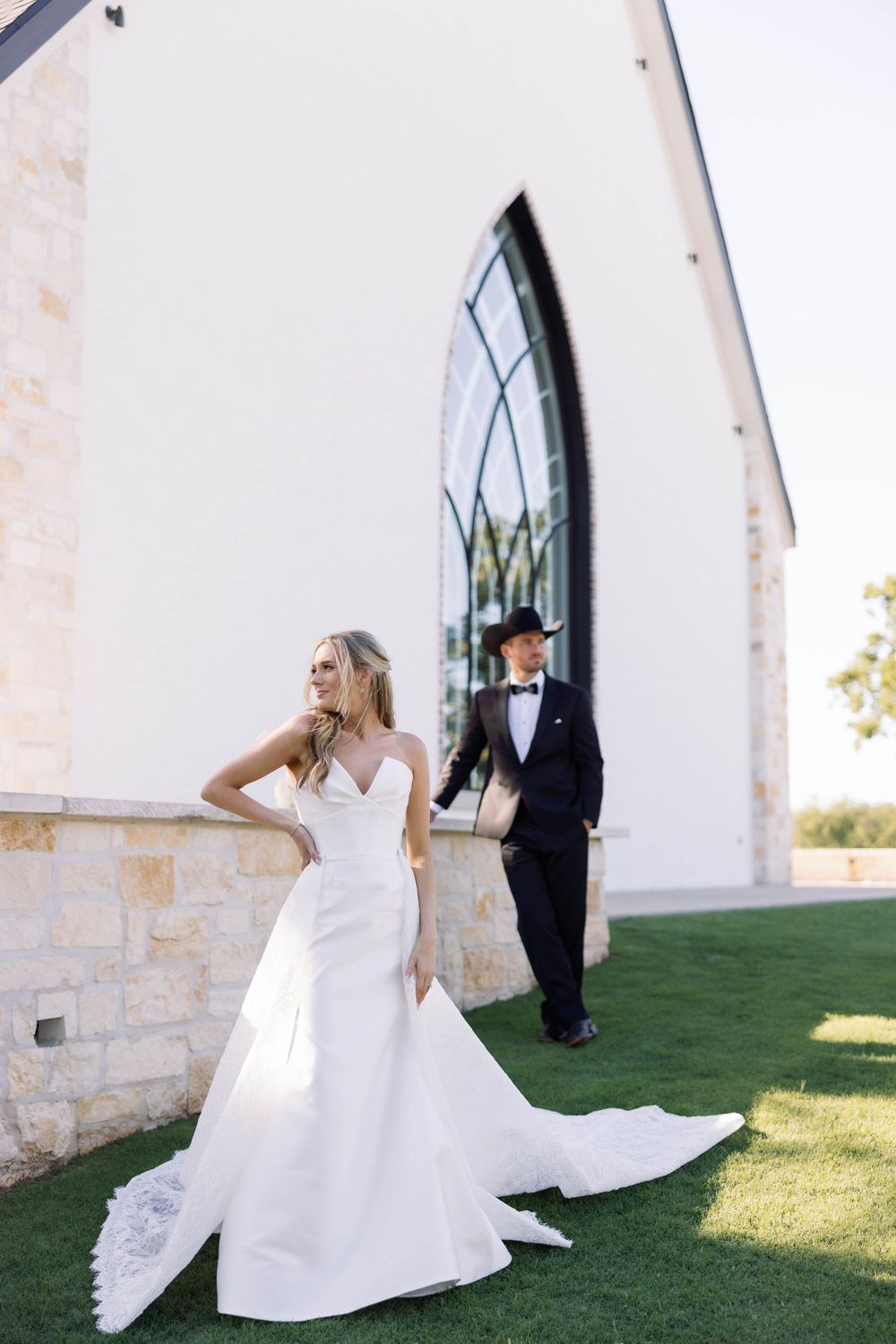 Four panel sequence shows newlyweds dancing outside a stone building on a grassy lawn.