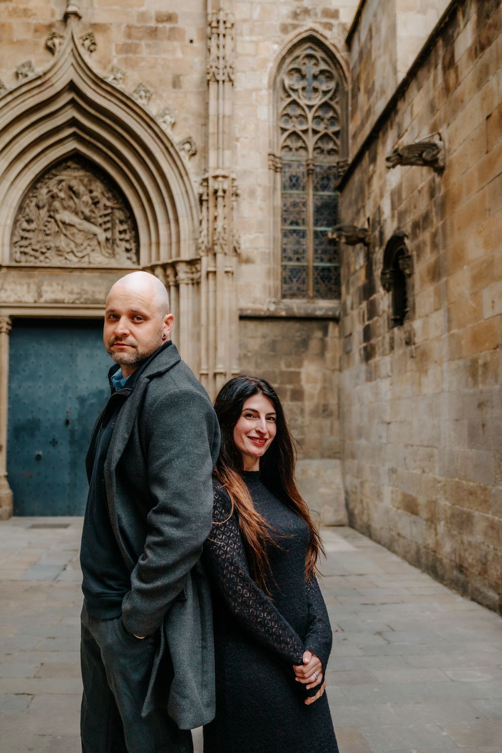 Elegant portrait of the couple against textured stone walls of the Old Town