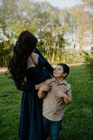 Intimate family moments photographed against natural greenery backdrop.