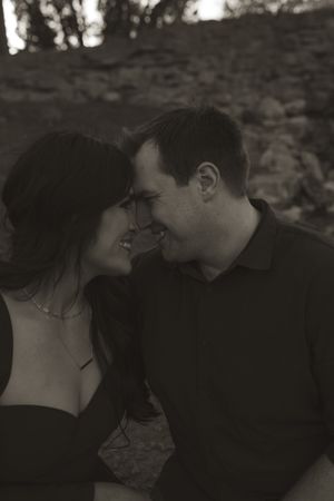A romantic black and white photo series captured against a textured stone backdrop.