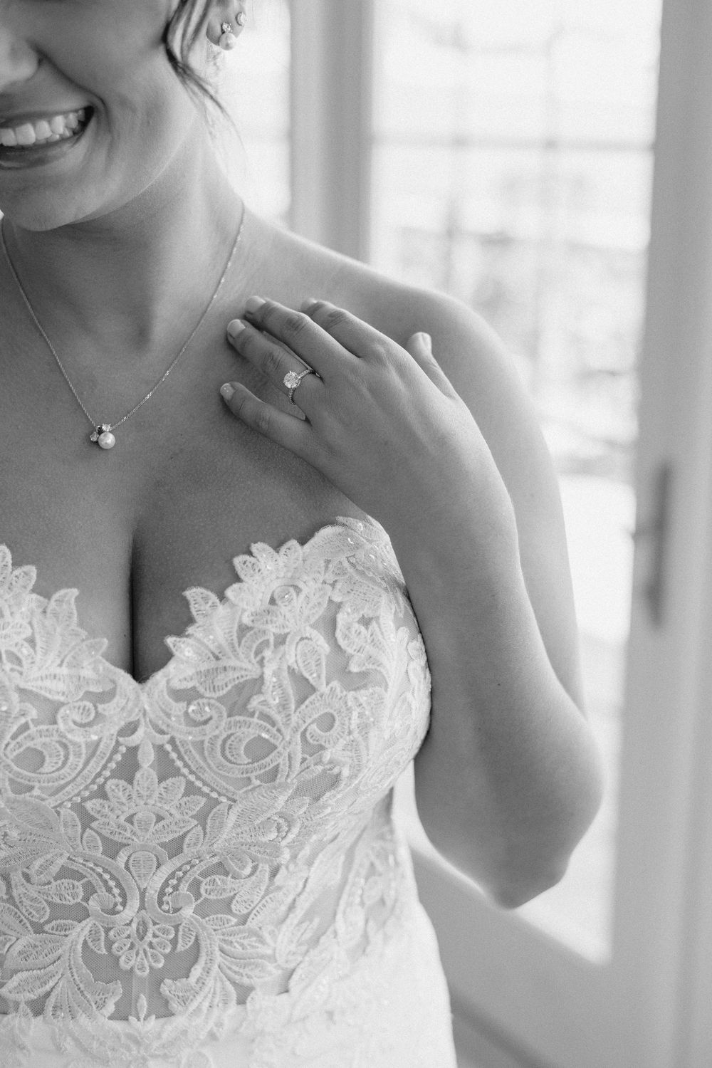 Close-up detail shots of delicate white lace on a wedding dress bodice.