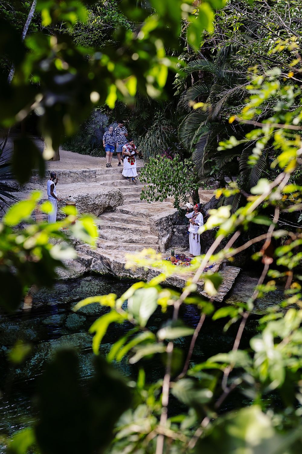 Aerial view of the cenote and the ceremony space with the couple and shamans at Kantun Chi.