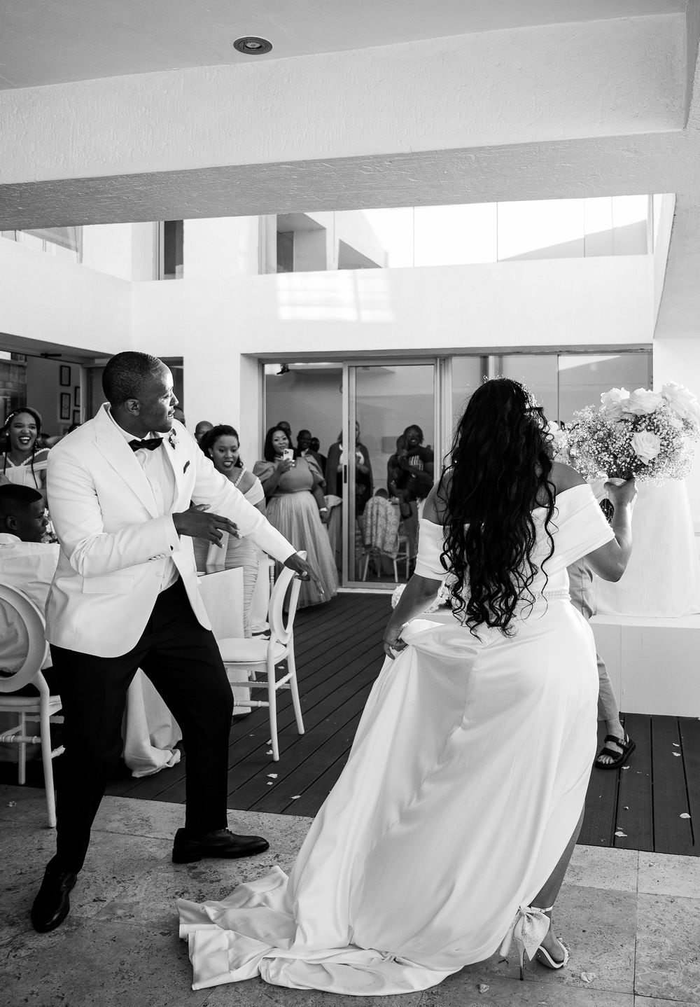 A sequence of romantic wedding dance moments showing a couple twirling and dipping in a white dress and formal attire.