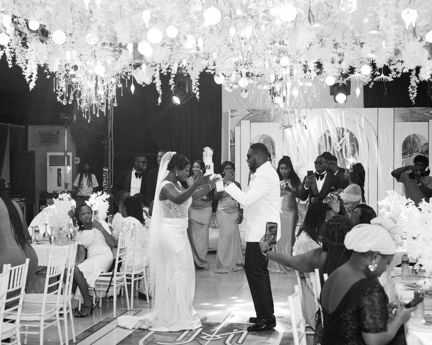A dramatic black and white silhouette of a couple sharing an intimate moment during their wedding photoshoot.