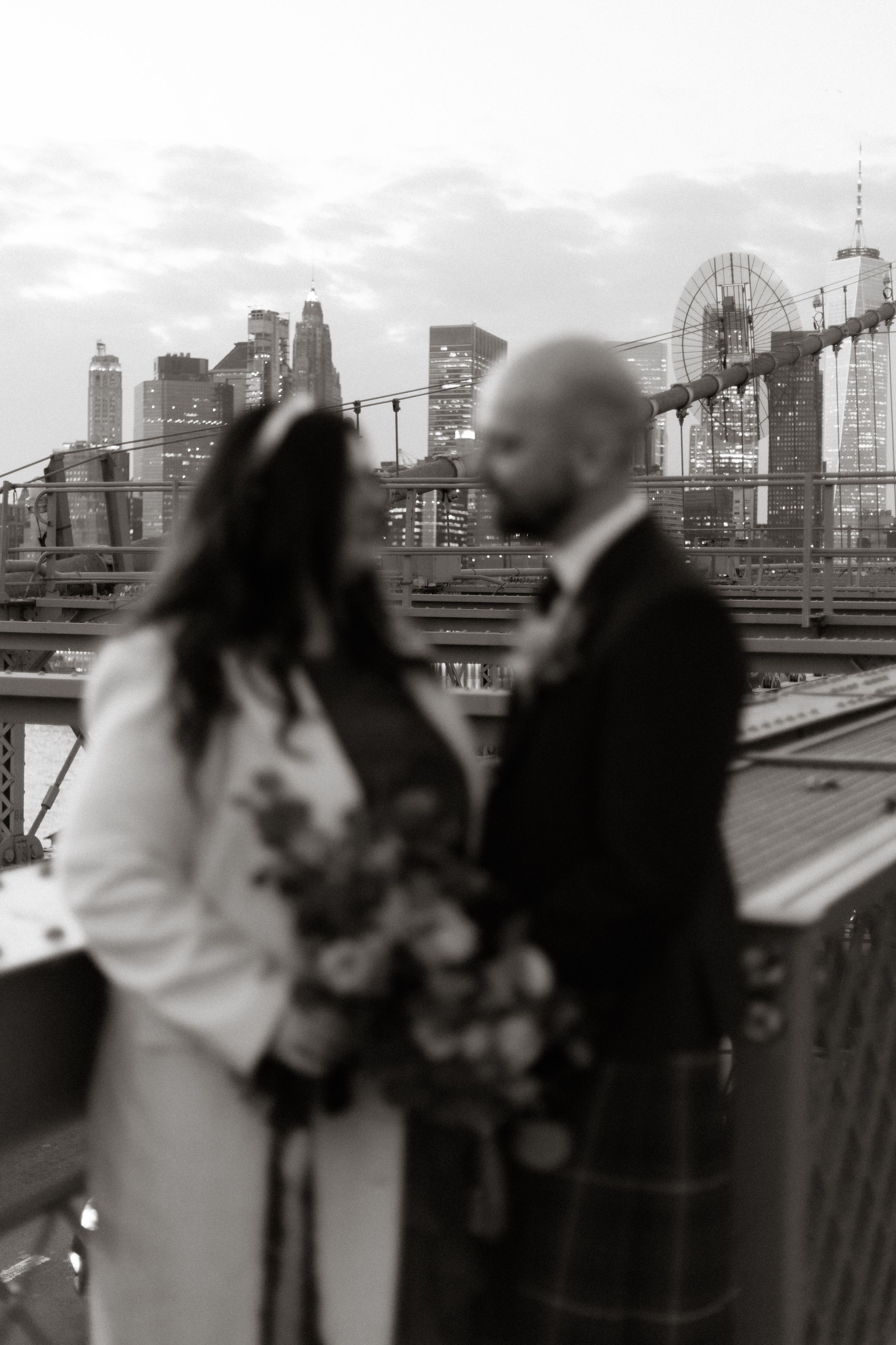 Black and white cityscape silhouette showing multiple people gathered on an urban rooftop against a modern skyline.