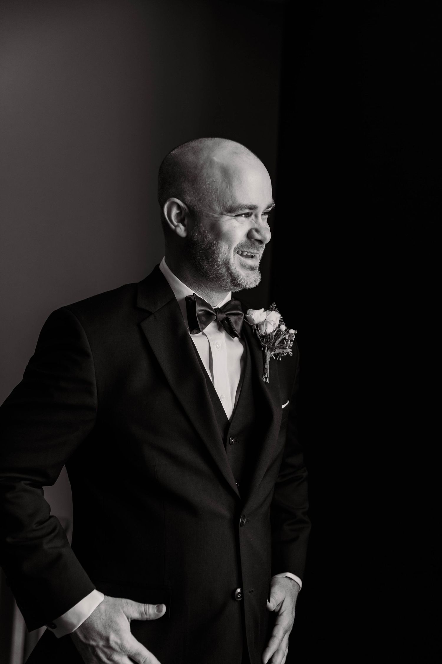 Candid black and white shots of groom preparing for wedding ceremony.