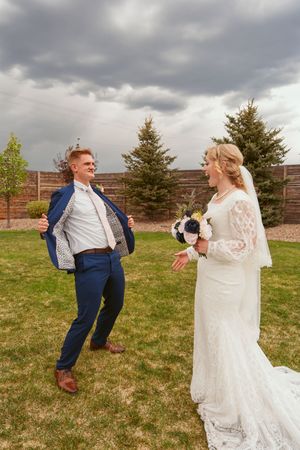A playful sequence of newlyweds dancing and twirling outdoors on their wedding day with cloudy skies overhead.