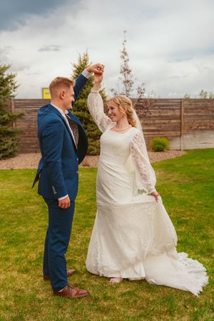 A romantic wedding photo sequence shows a couple dancing playfully on a green lawn near a wooden fence.