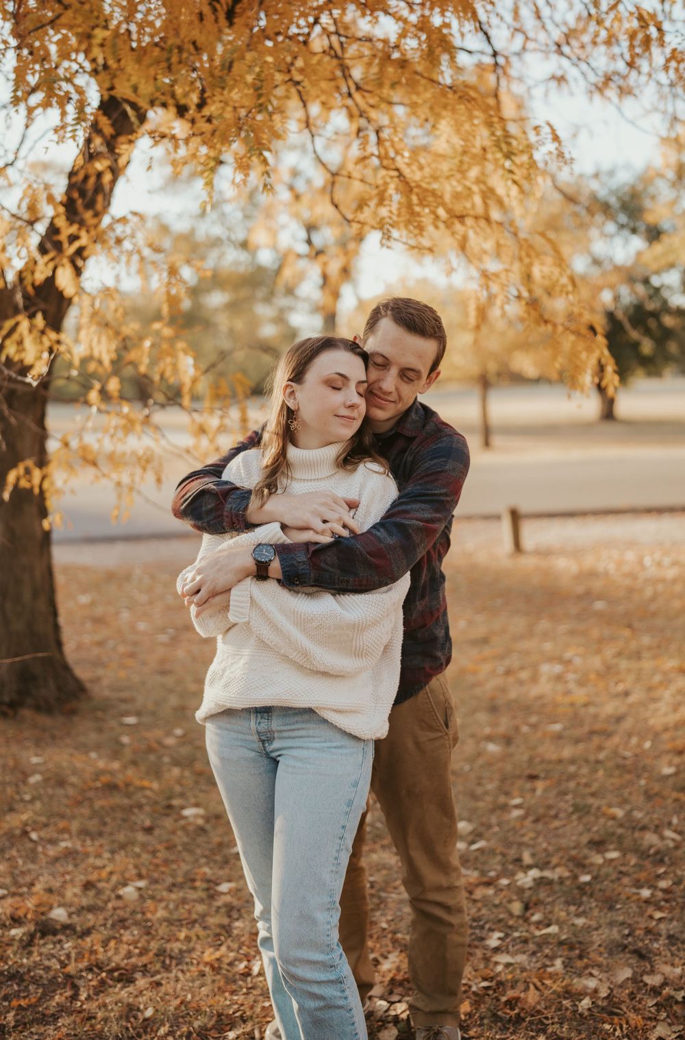 Warm fall couples photo under yellow trees during golden hour in Wichita