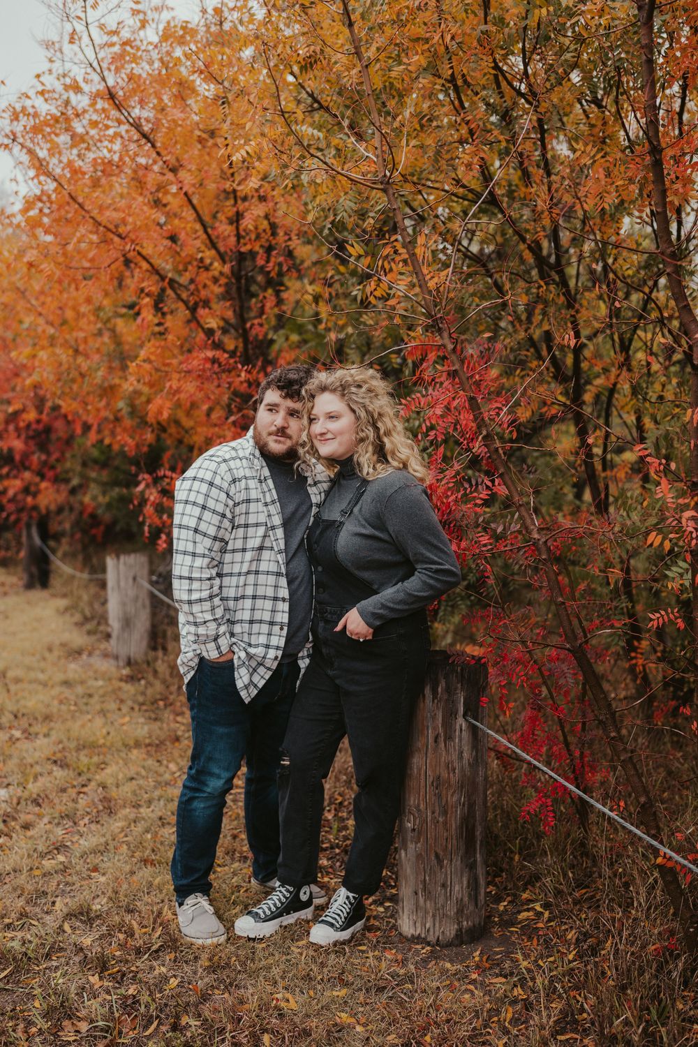 Bold autumn couples session with colorful fall foliage in Wichita