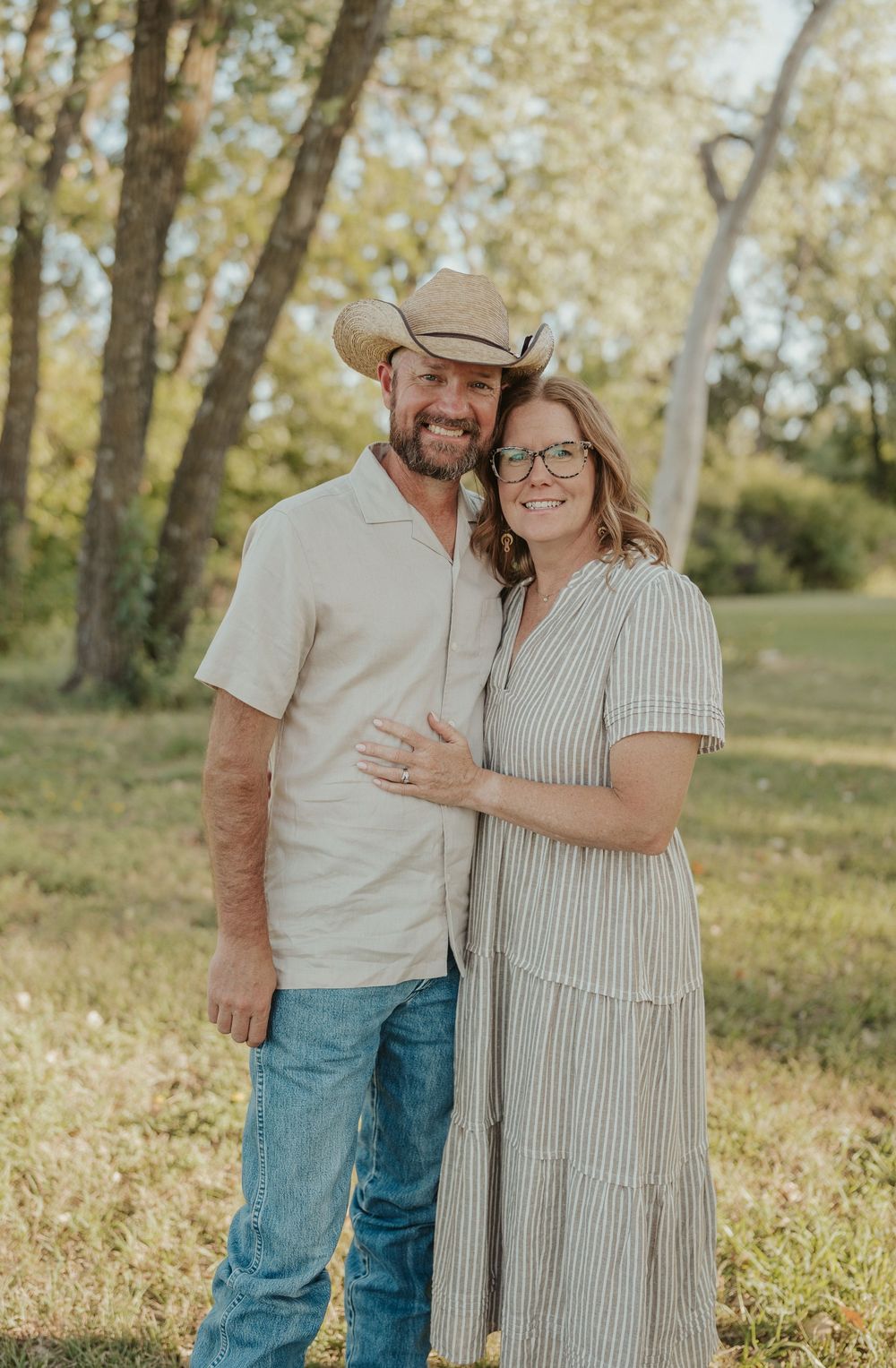 Golden hour couples photo in Kansas field with rustic western style