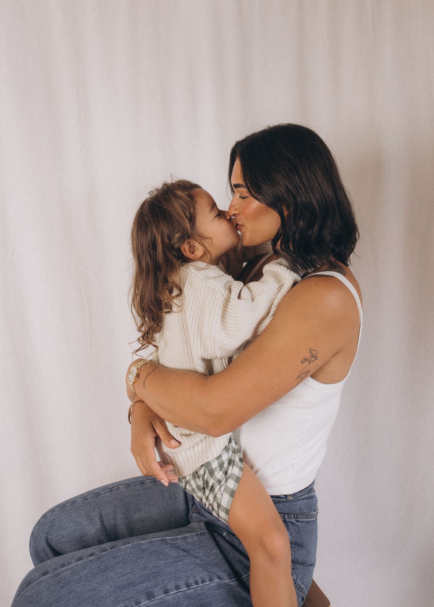 Mother and young child sharing a tender nose kiss while embracing in New Zealand.