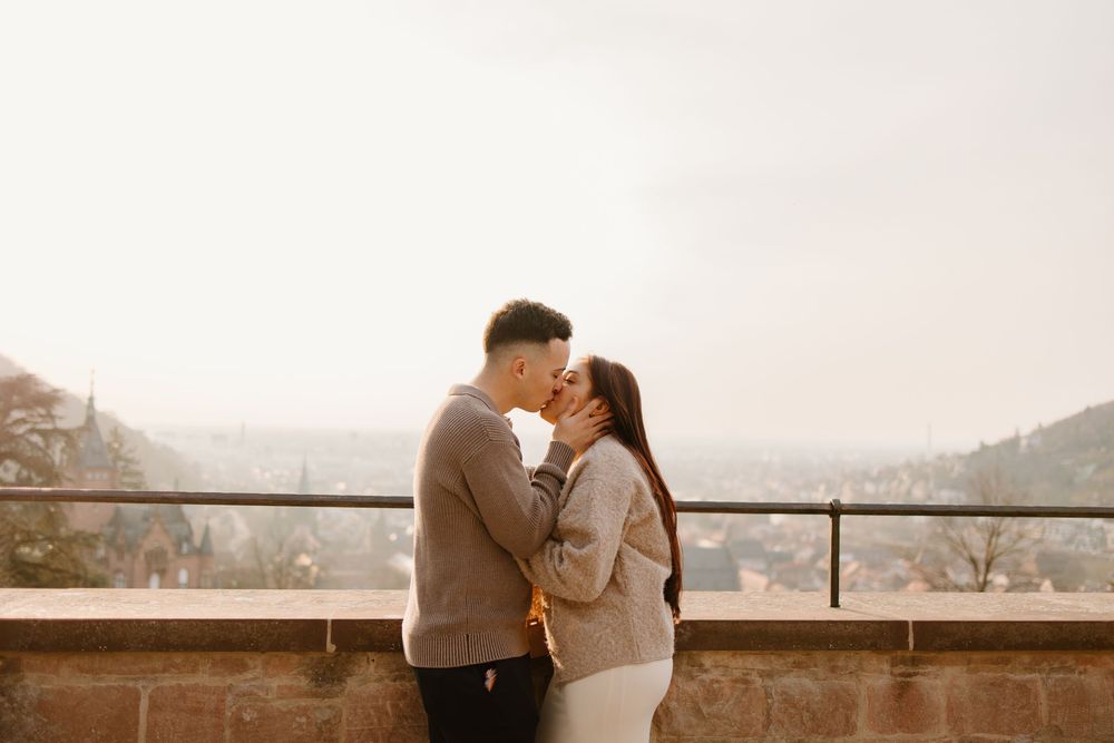 Heidelberg Proposal Photography, Couple celebrating proposal at castle with panoramic view of Heidelberg in the background