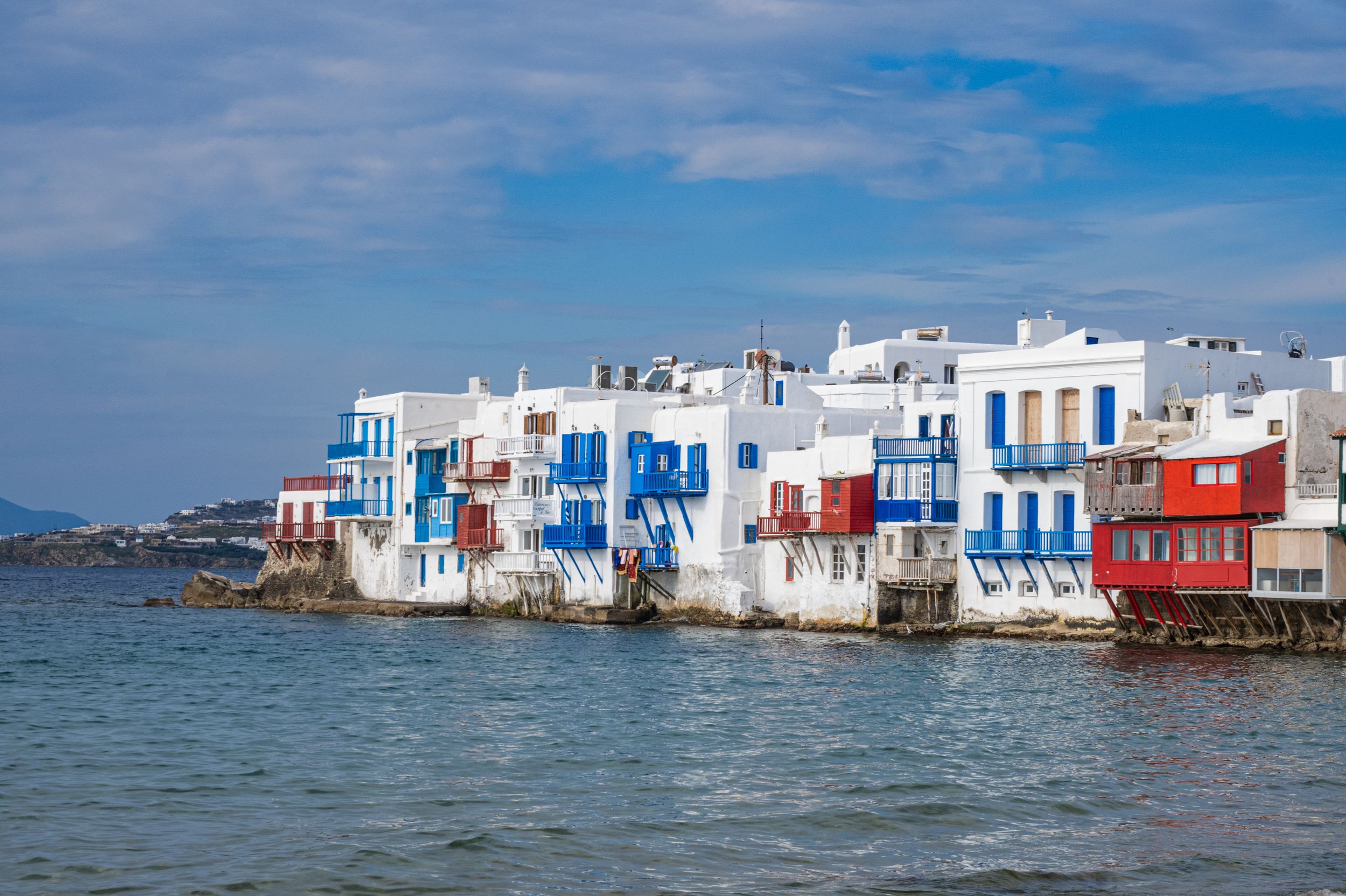 Panoramic view of colorful traditional houses along the waterfront in Mykonos Little Venice, Greece.