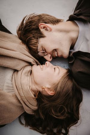 Close-up black and white photograph showing couple in romantic embrace.