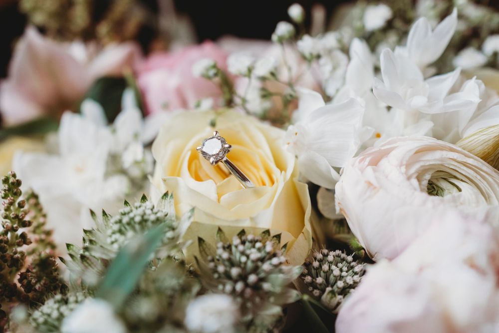 Close up of wedding flowers and engagement ring at Parc Le Breos in Gower, West Wales