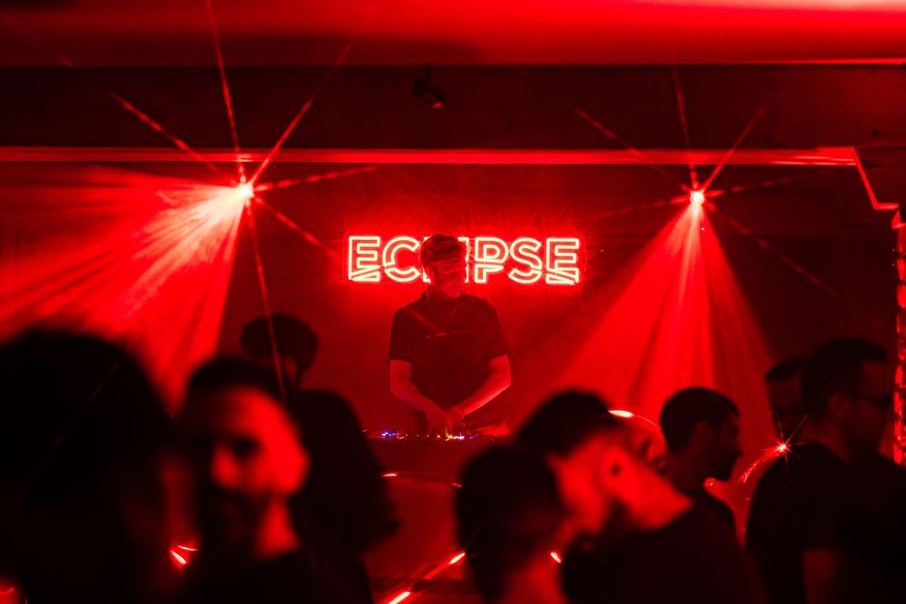 Ryan Mcclure, a DJ for the nightlife event Eclipse, performs for partygoers attending and dancing at Epiphany Center in Chicago