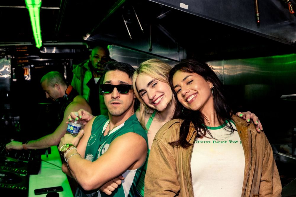 DJ Michael Navarro poses for a photo with two attendees of Get Lucky during his set in the basement at DS Tequila in Northalsted Chicago