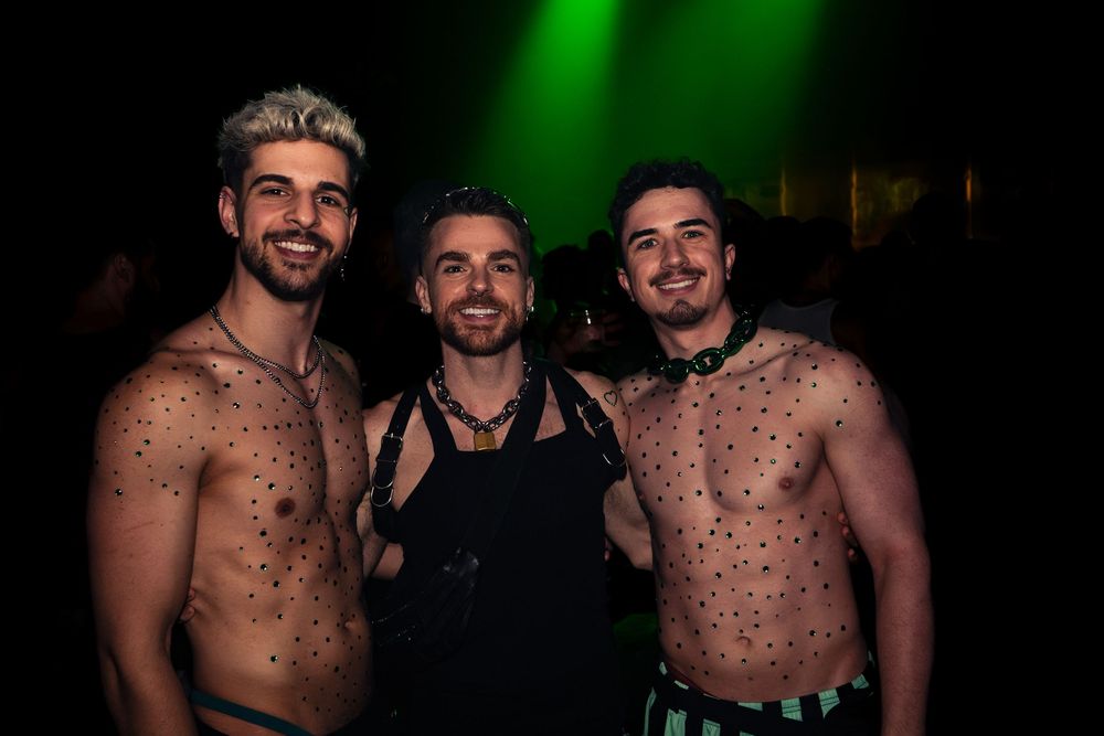 Three partygoers pose for a picture at a nightlife event in Chicago