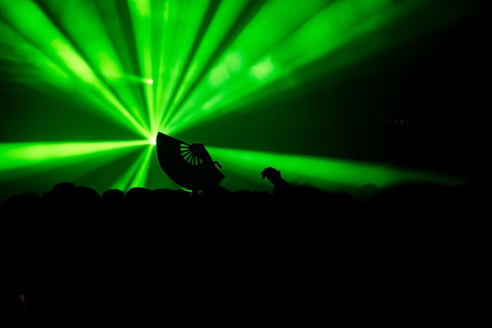A partygoer dances with the rest of the crowd in the background at a nightlife event called Requiem in Chicago at Epiphany Center