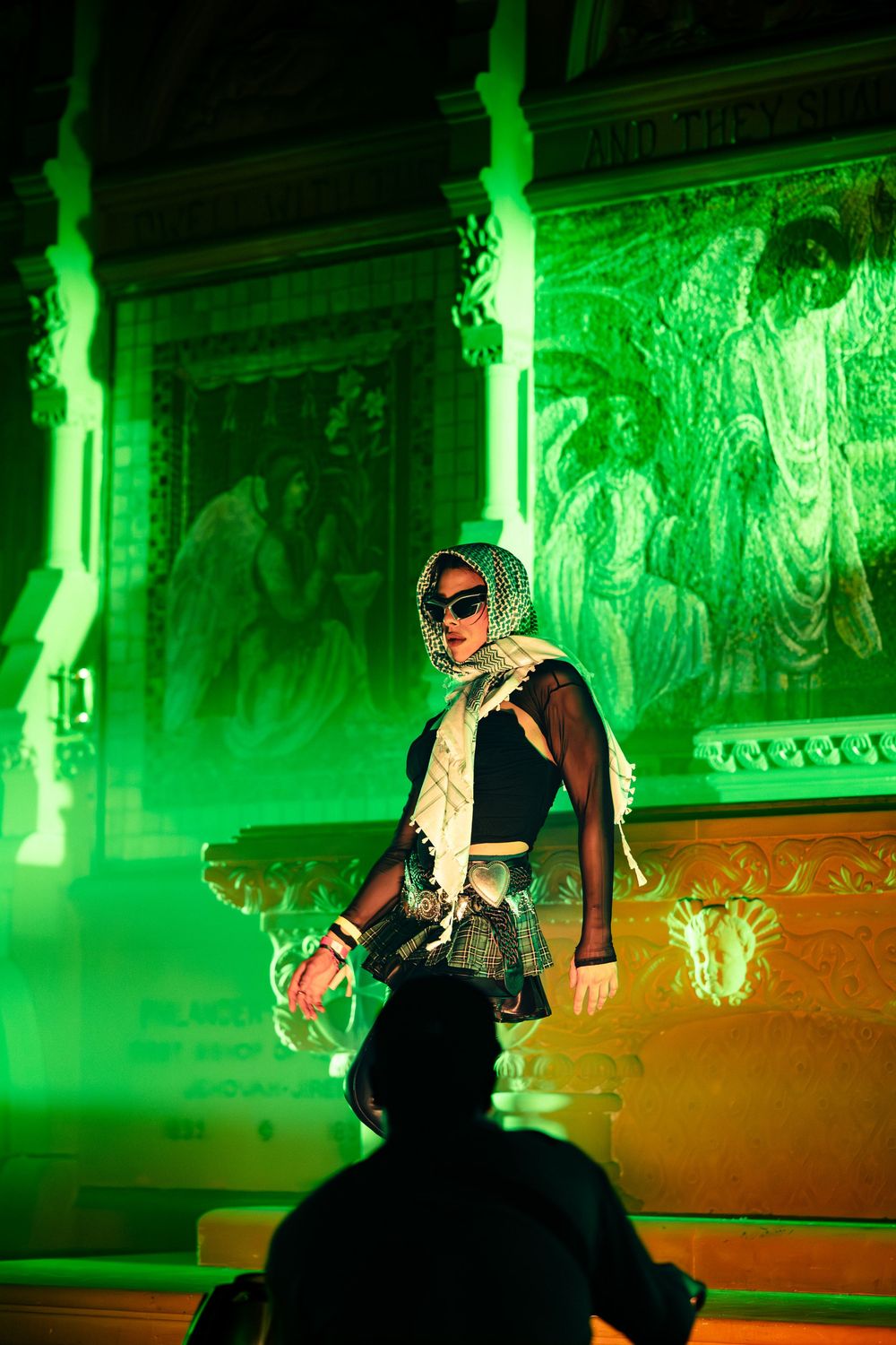 A host of a nightlife event in Chicago struts down the steps at Epiphany Center