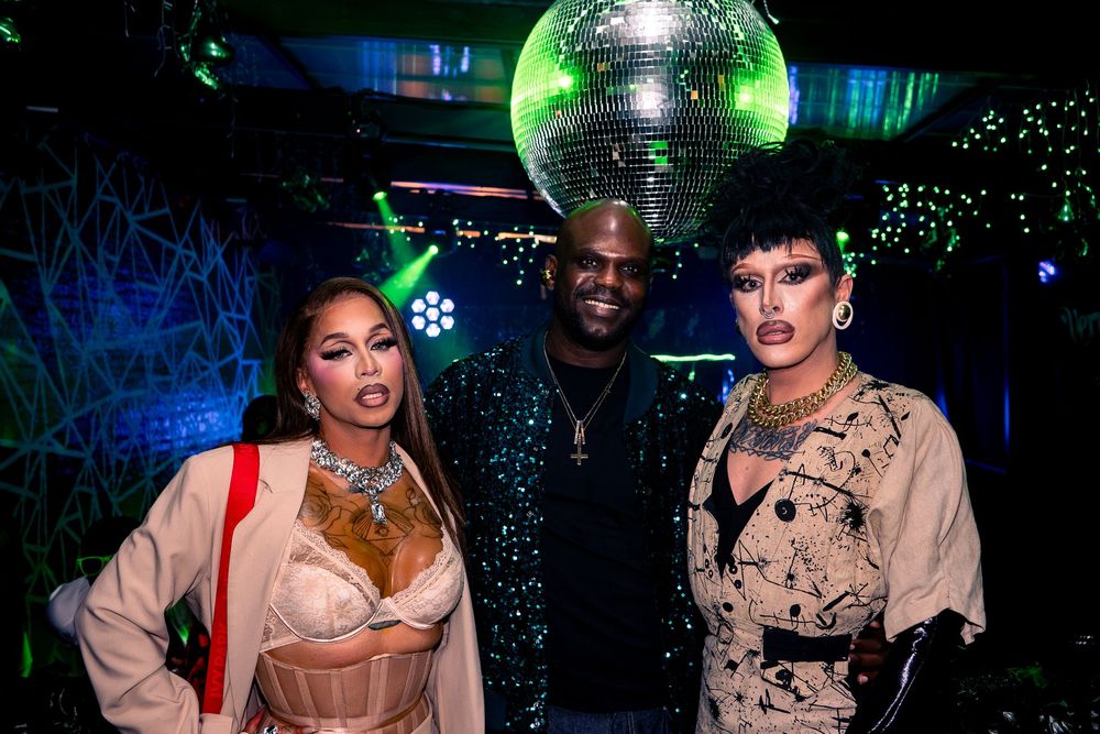 A host and two attendees poses for a picture at a nightlife event in Chicago
