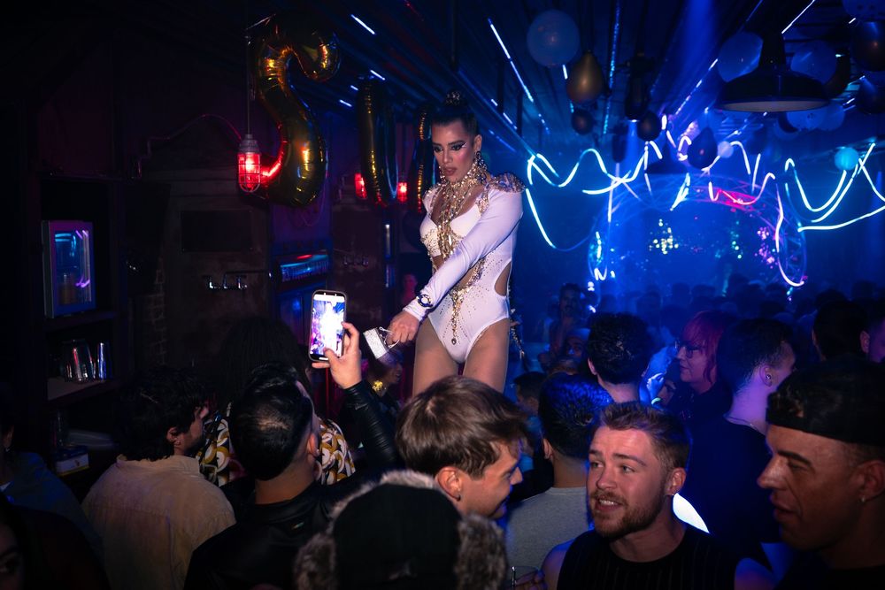 A host of a joint CircuitMom and Dusty Carpenter produced event dances on the bar counter at DS Tequila in Northalsted Chicago