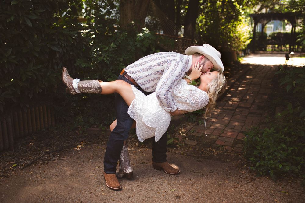 A series of seven photos showing a couple performing a dance dip move on a tree-lined path.