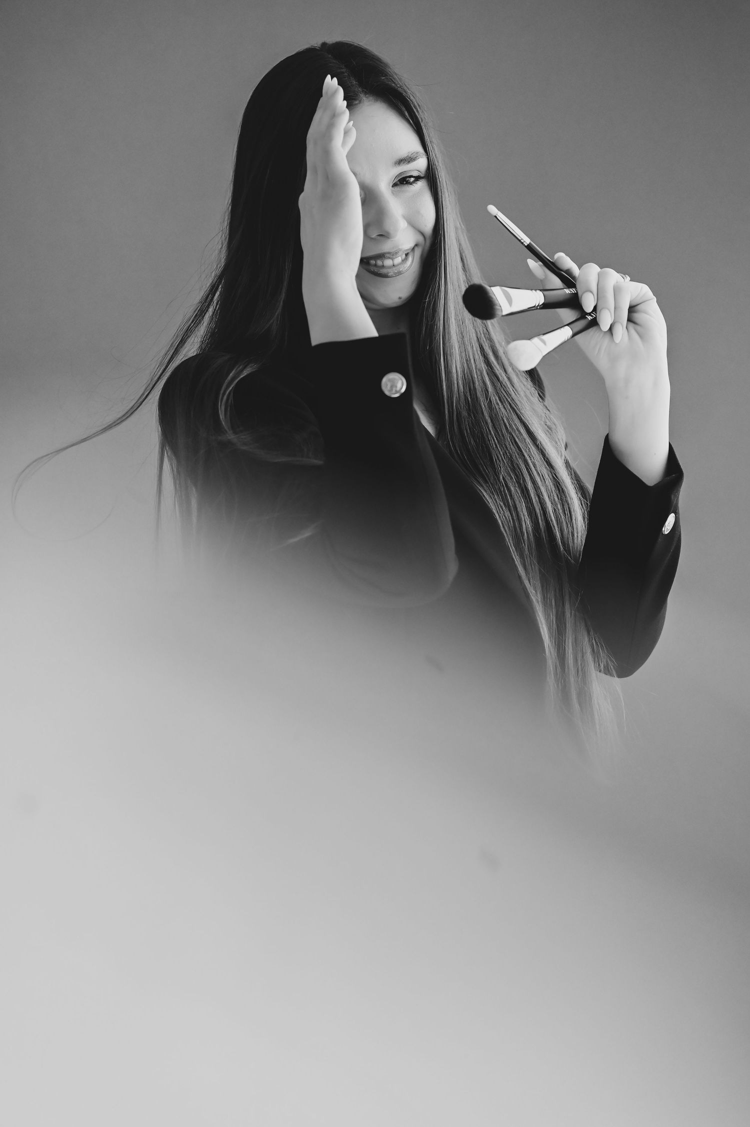 Black and white portrait series showing a woman with long dark hair singing into a microphone in different poses.