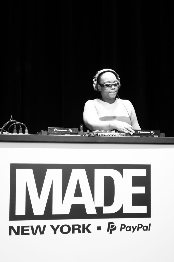 Female DJ wearing headphones mixing at Pioneer DJ decks at MADE New York PayPal fashion event.