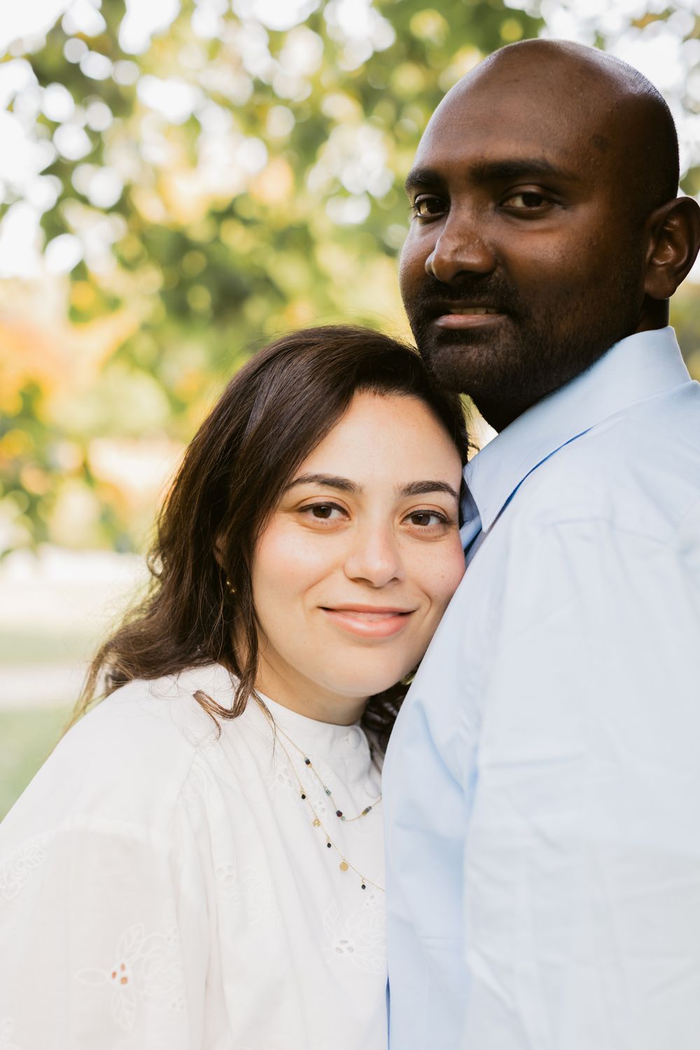 Woman with dark hair rests head on man's chest at Garden at Elm Bank in Wellesley, Massachusetts. North Shore couple photographer.