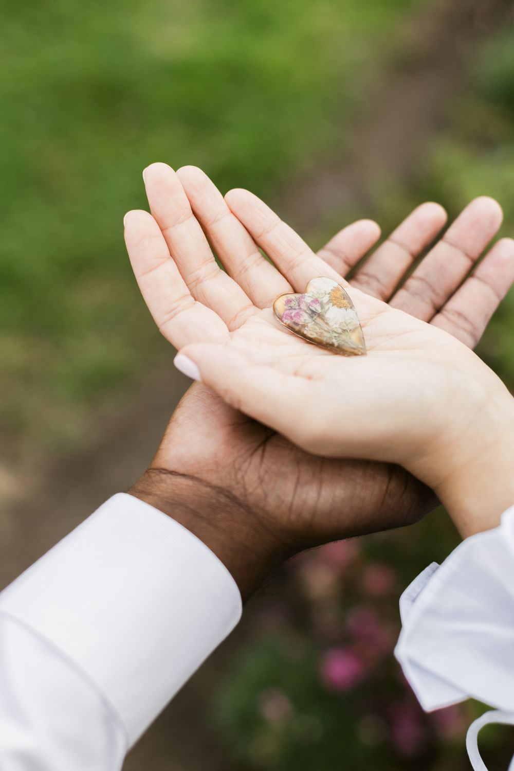 Man and woman hold a glass heart with dried flowers in it for couple photos. Southern Maine couple photographer