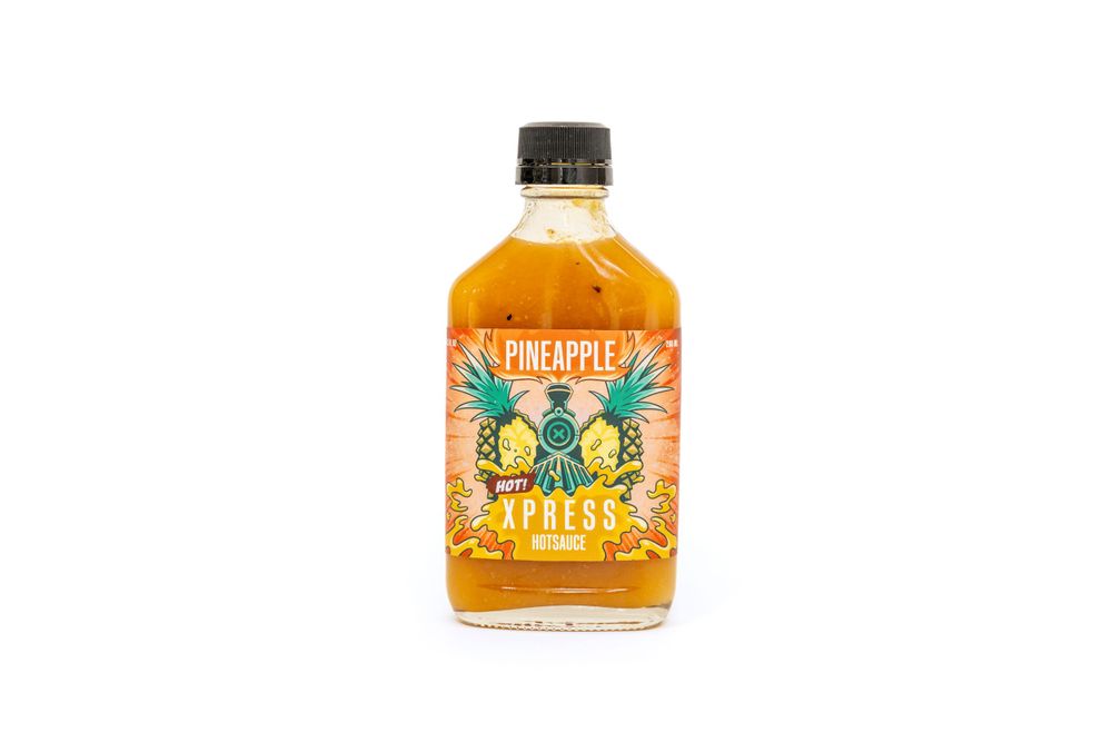 A glass bottle of orange-colored Suavecito Firme pomade with blue and yellow label design.