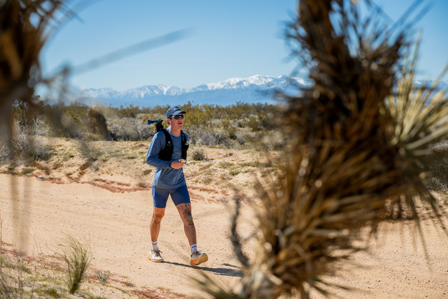 Ultra runner walking through the Joshua Trees in the middle of a multi-day 300+ mile race