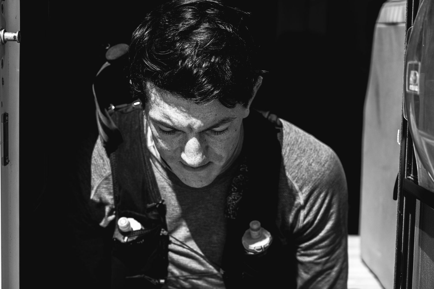 Dramatic black and white portrait showing someone in shadow.