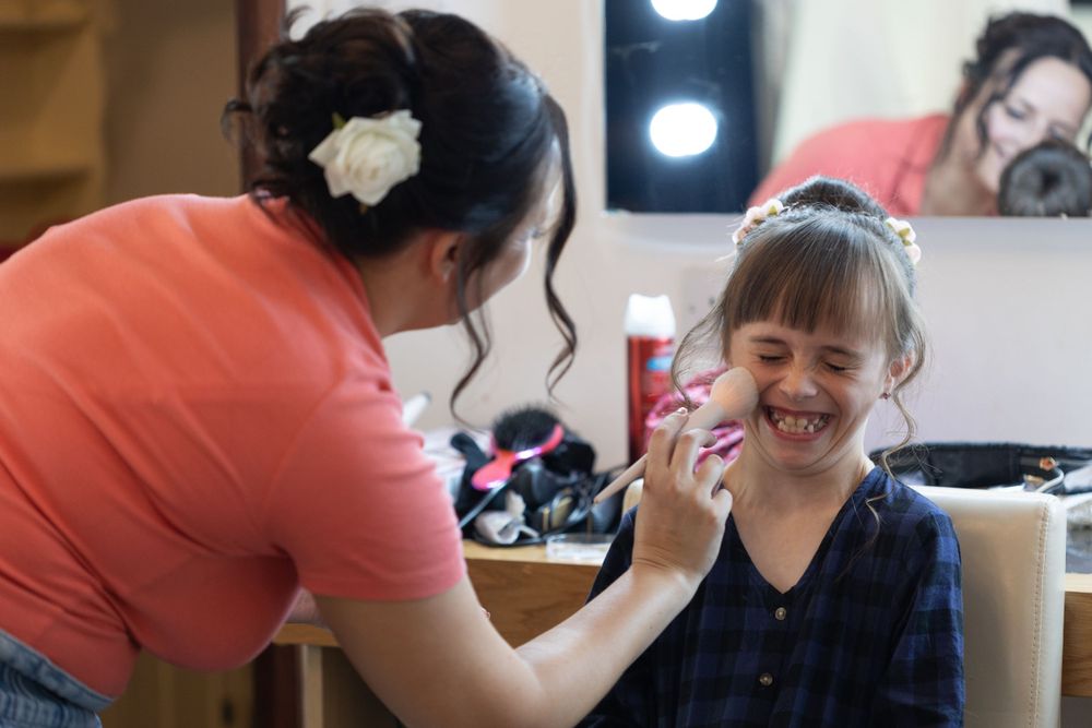 Flower girl laughing as she gets her makeup done Blackstock country estate