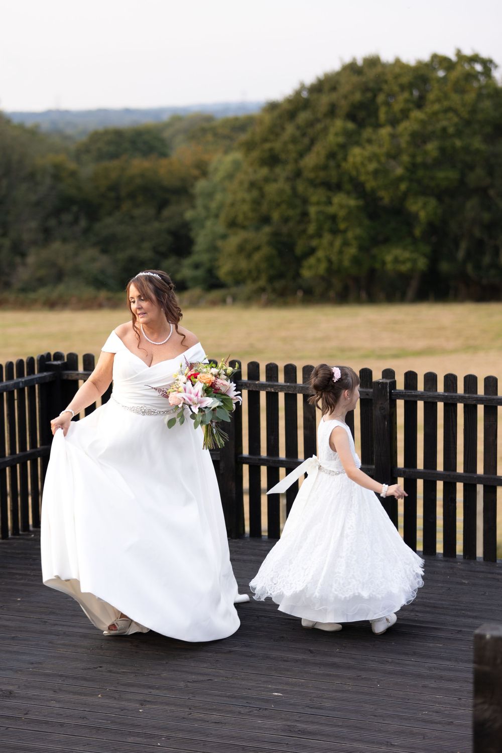 Bride and flower girl twirling Blackstock country estate