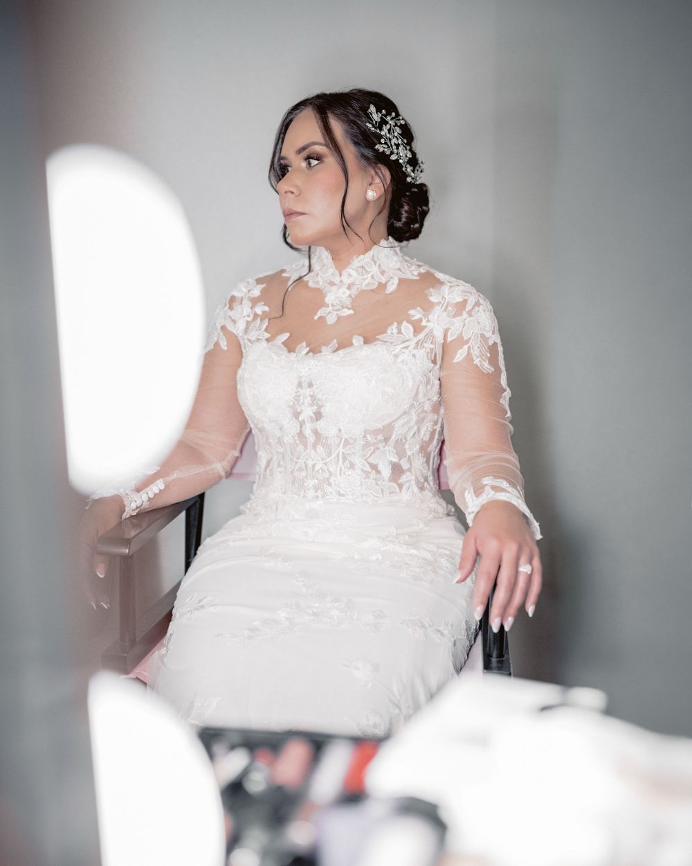 Elegant bridal portrait during wedding preparation, bride wearing a lace wedding dress in soft natural light