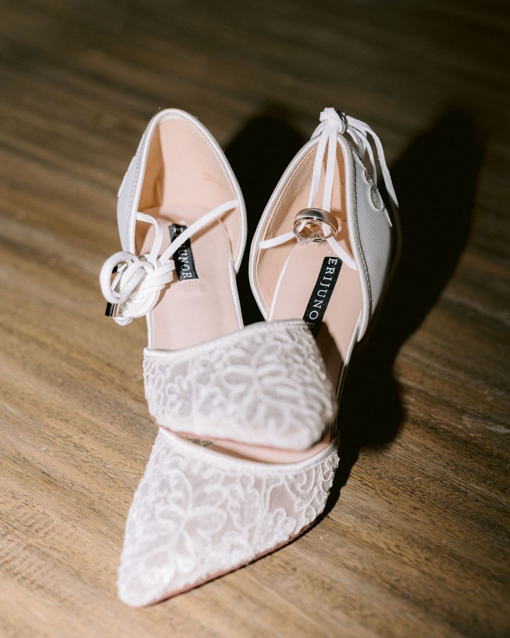 Elegant white lace bridal wedding shoes displayed during bridal preparation