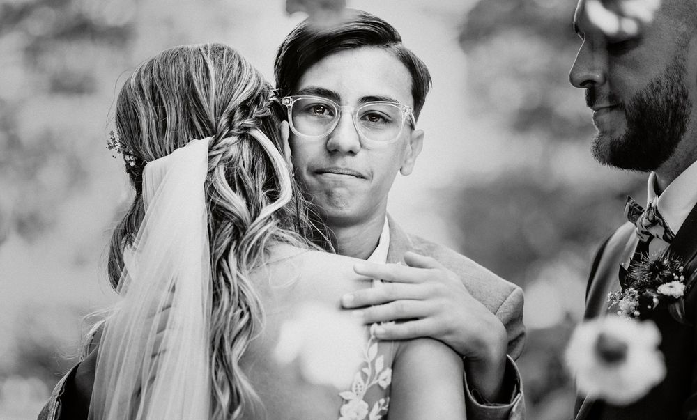 Black and white photo showing an emotional intimate moment between wedding couple during their ceremony.