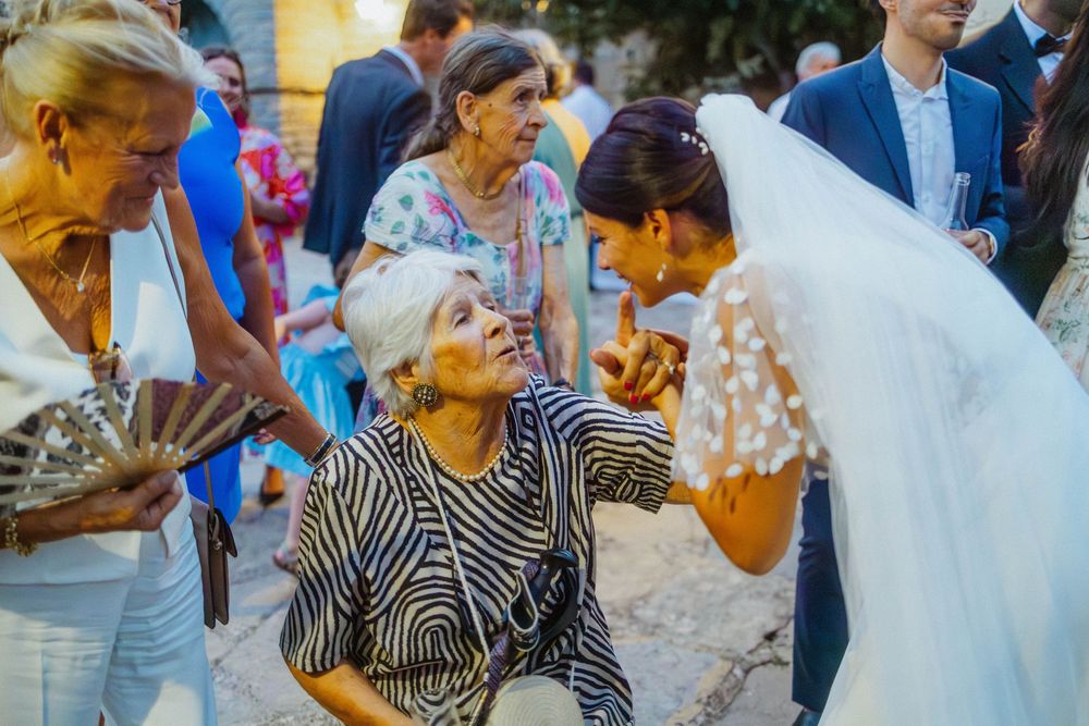 Wedding guests enjoying champagne and celebrating at an outdoor reception.