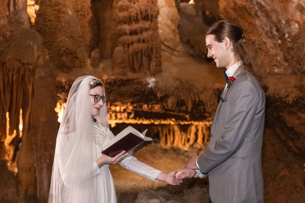 Couple exchanging vows in a stunning cave wedding ceremony surrounded by stalactites and stalagmites.