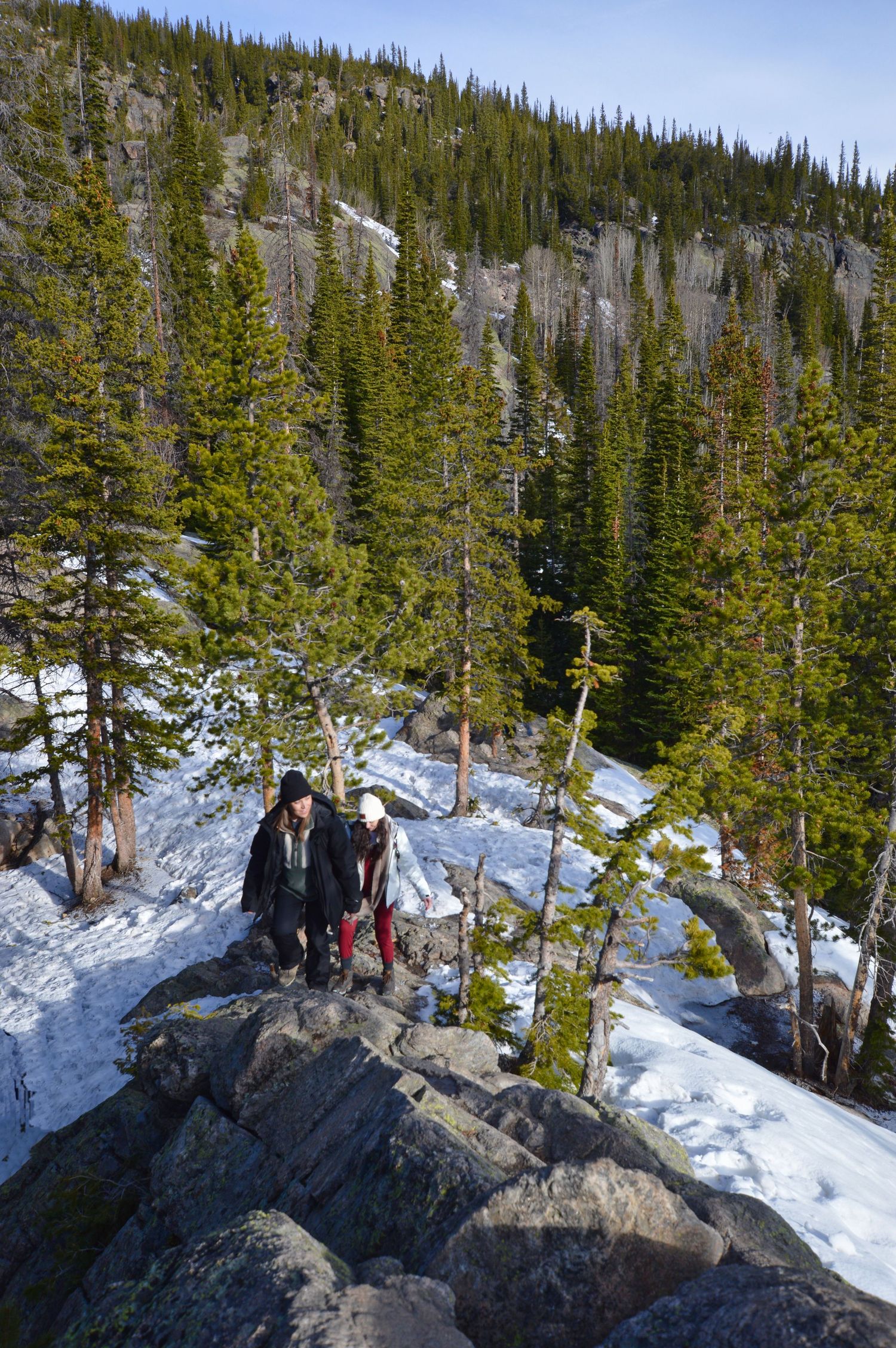 Couple Climbing up a ridge in Rocky Mountain National Park. Pixcapades | The Rocky Mountain Proposal Photographer
